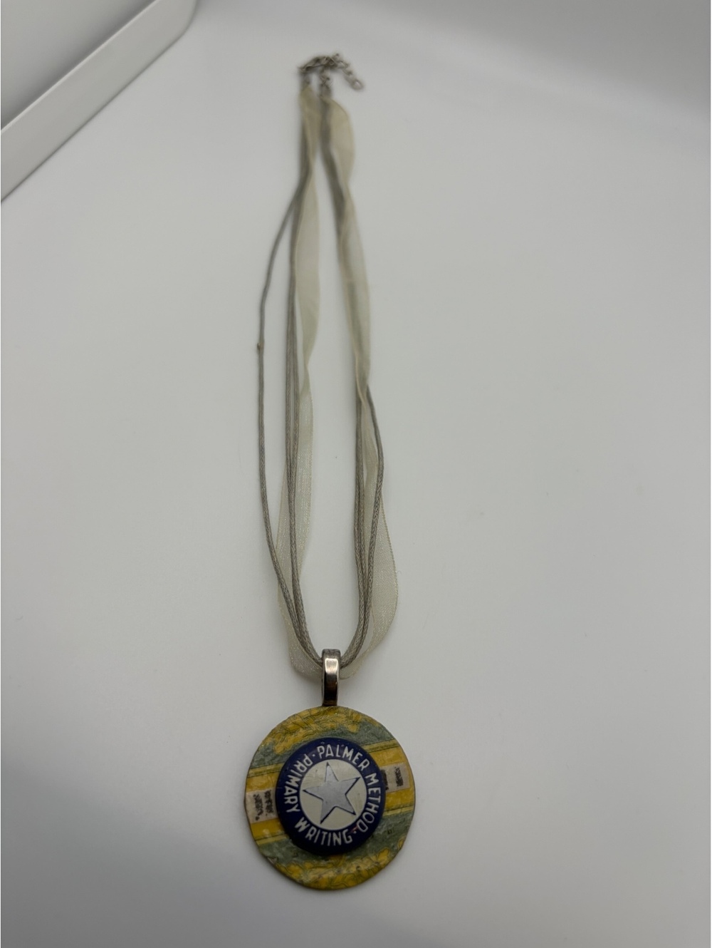 Ribbon necklace with round palm tree pendant